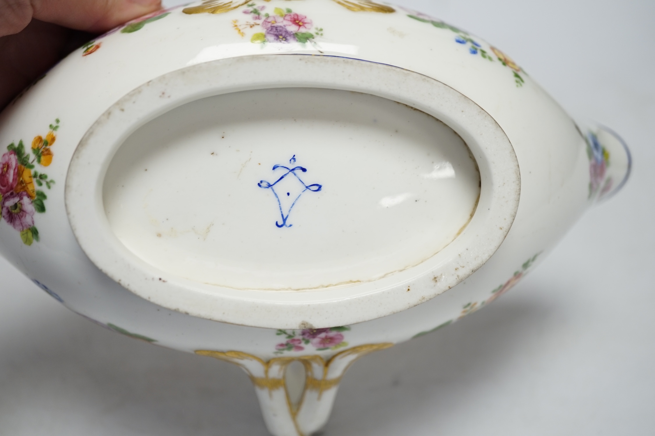 An 18th century Sevres sauceboat, probably later enamelled with flowers, 23.5cm wide